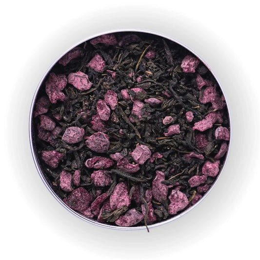Tea leaves with pink petals in a metal tin on a white background