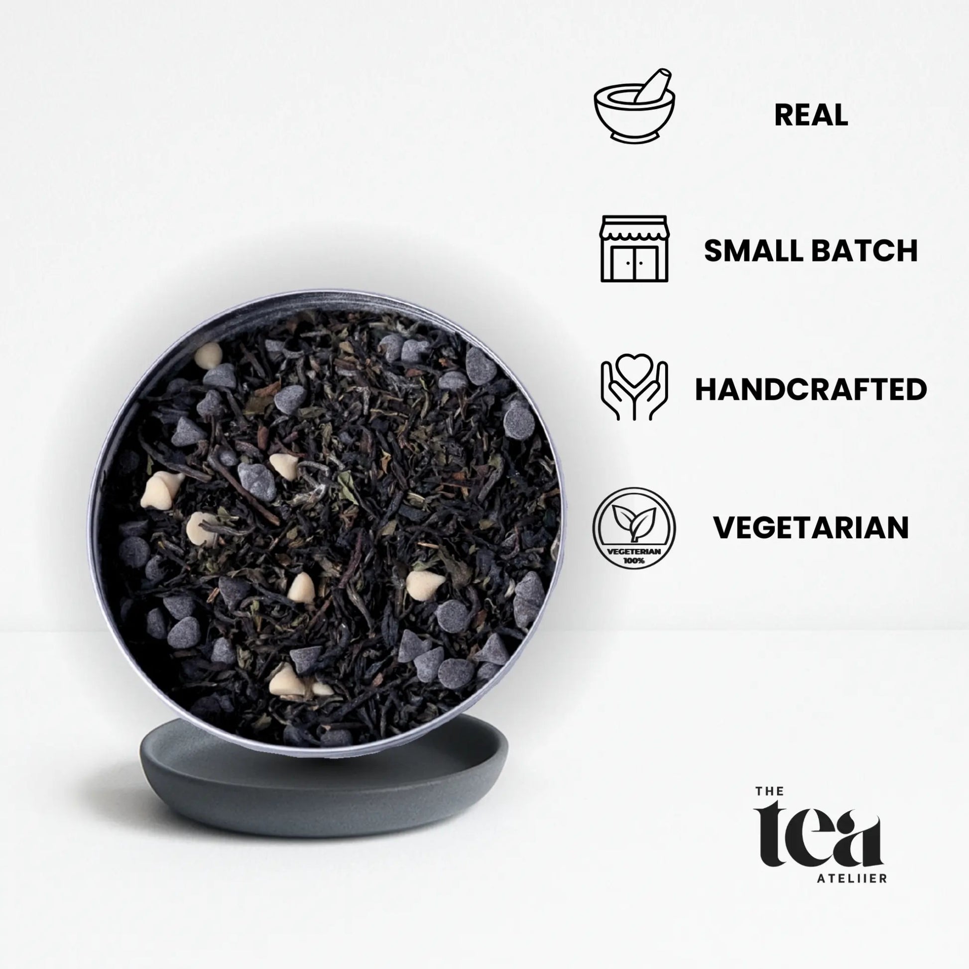 Tea leaves in a black bowl by The Tea Ateliier