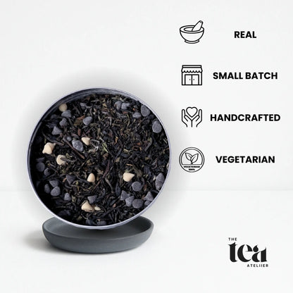 Tea leaves in a black bowl by The Tea Ateliier